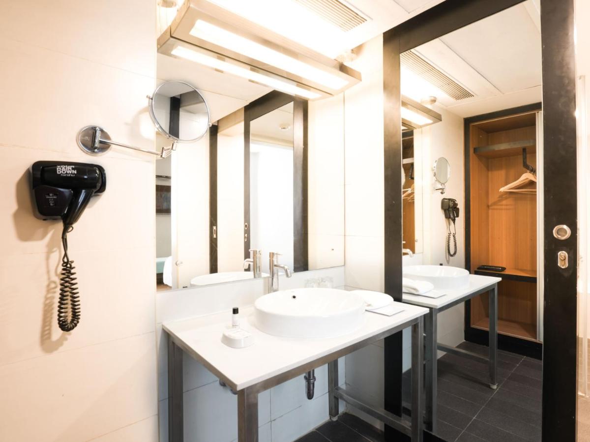 a bathroom with two sinks and a phone on the wall at Sunday Hotel Chandigarh Zirakpur in Zirakpur