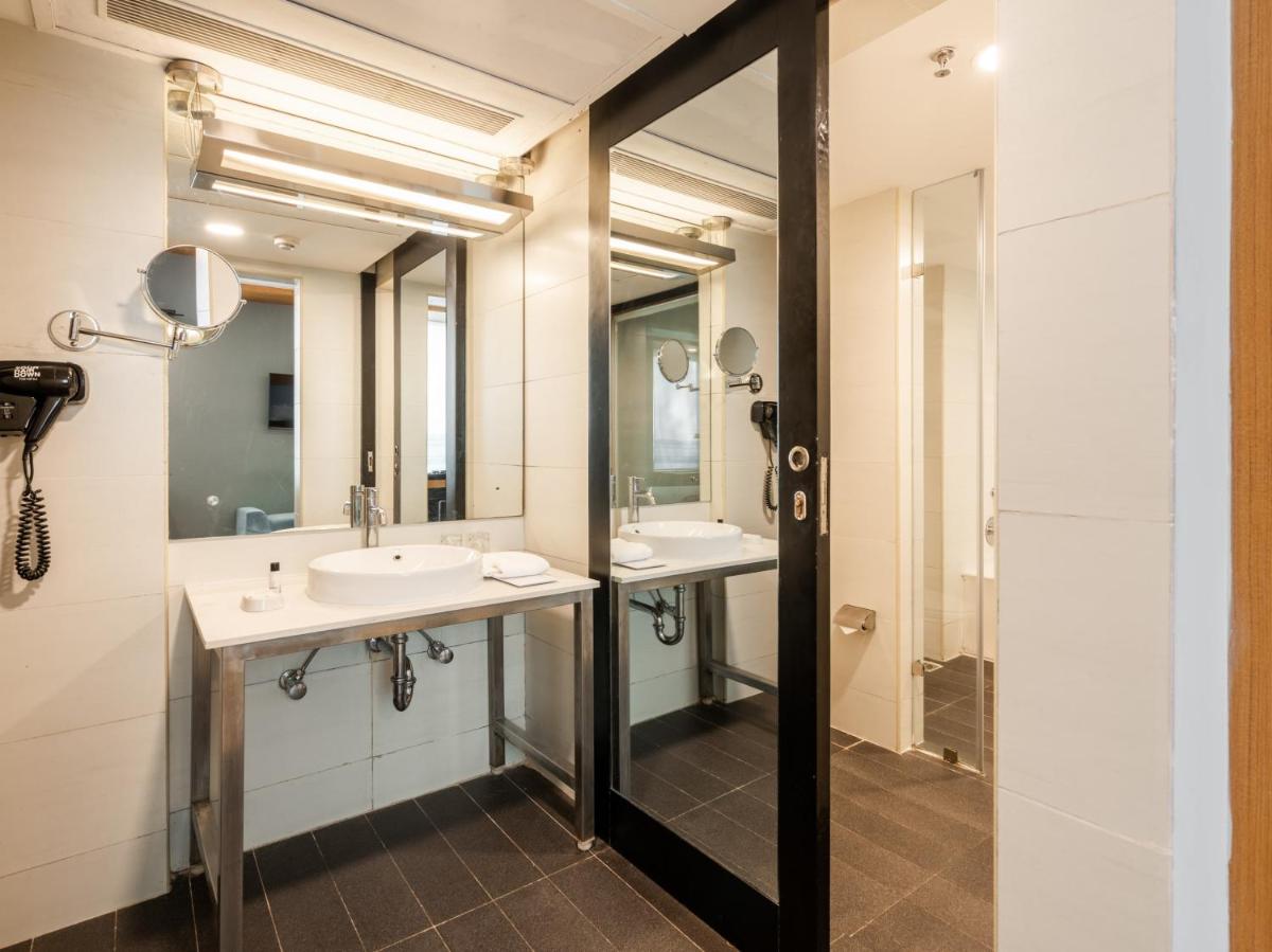 a bathroom with two sinks and a mirror at Sunday Hotel Chandigarh Zirakpur in Zirakpur