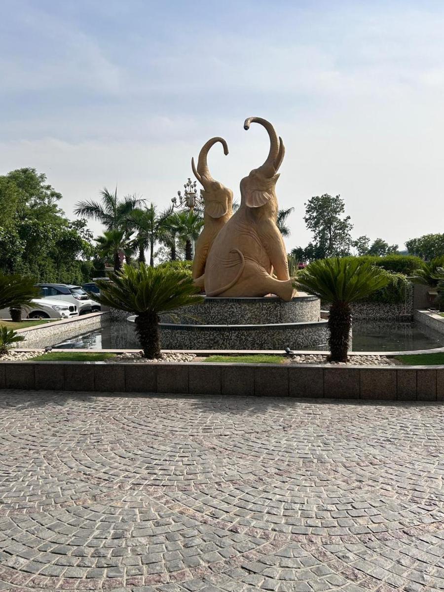 a statue of two women sitting on a bench at Saura Hotel, Agra - A Club Mahindra Associate in Agra