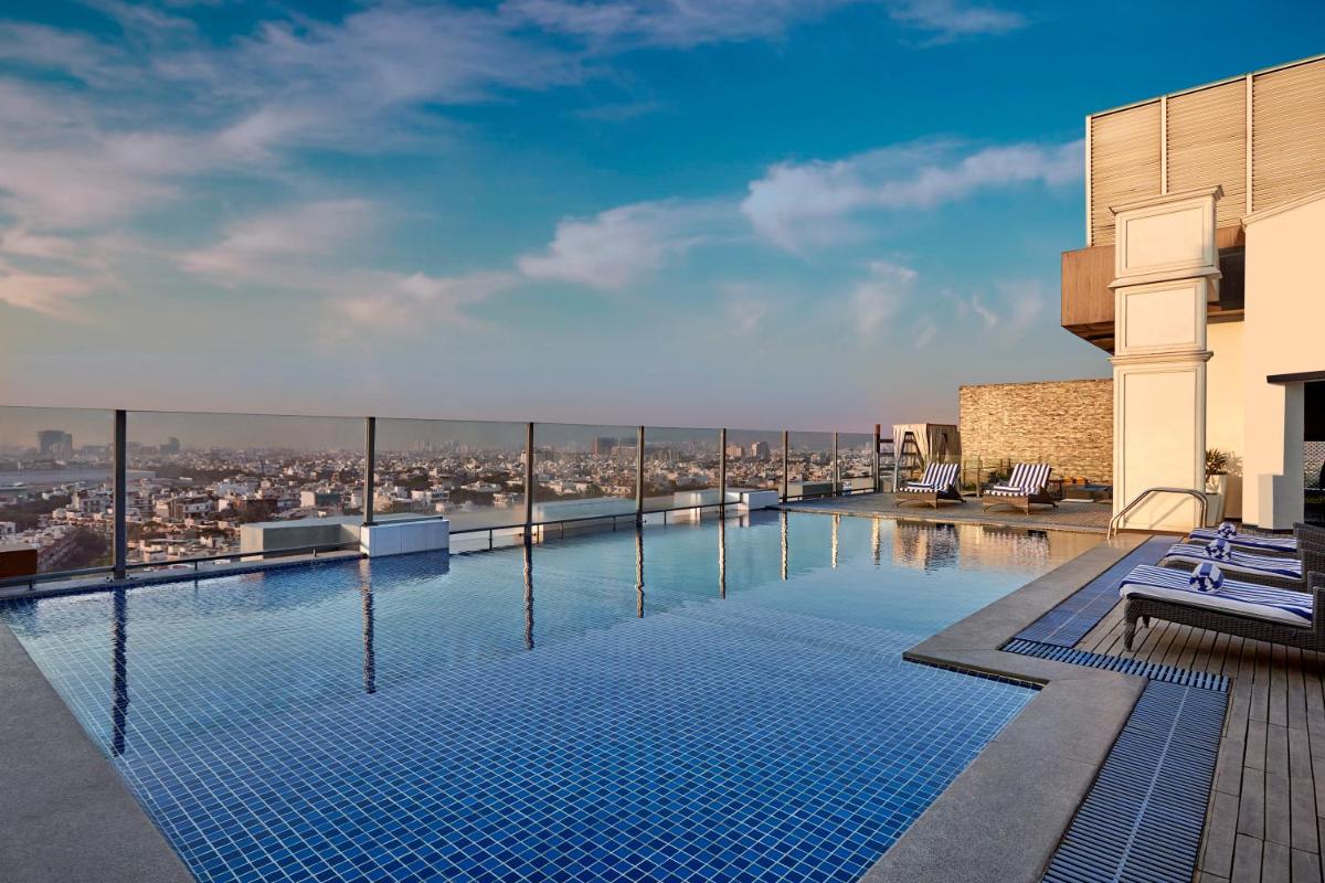 a swimming pool on the roof of a building at DoubleTree by Hilton Gurugram Baani Square in Gurgaon a swimming pool on the roof of a building at DoubleTree by Hilton Gurugram Baani Square in Gurgaon
