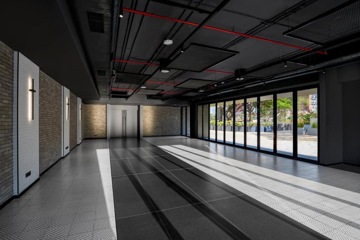 an empty hallway with a large room with windows at Hyatt Centric Hebbal Bengaluru in Bengaluru