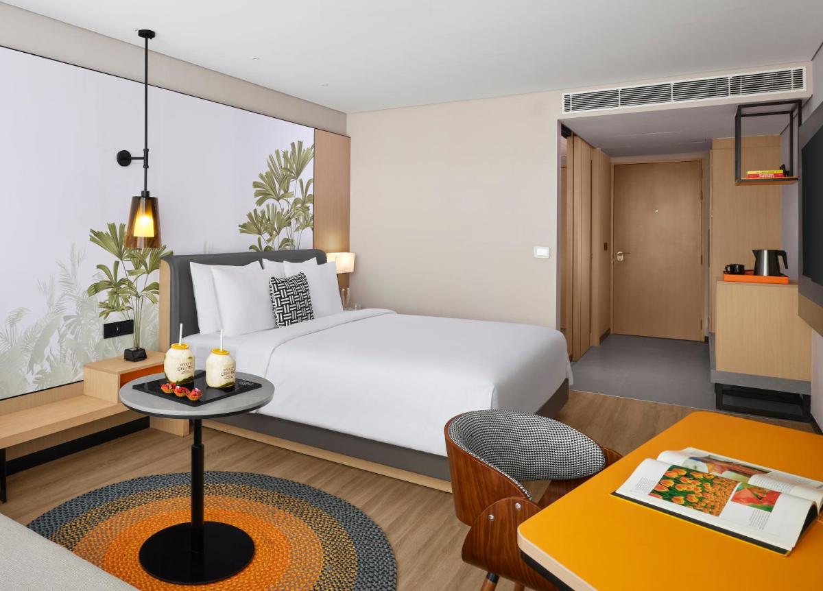 a hotel room with a bed and a table at Hyatt Centric Hebbal Bengaluru in Bengaluru