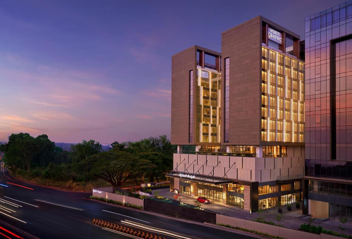 a rendering of a tall building with a highway at Hyatt Centric Hebbal Bengaluru in Bengaluru