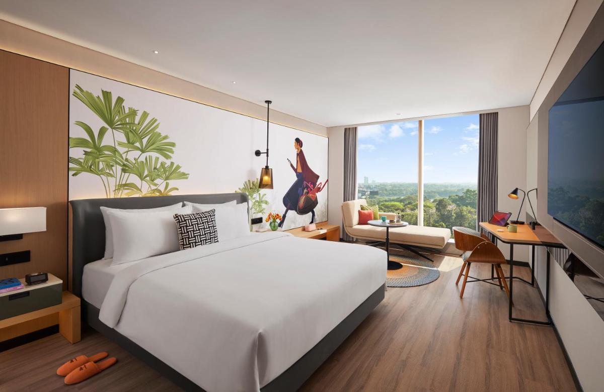 a bedroom with a white bed and a large window at Hyatt Centric Hebbal Bengaluru in Bengaluru