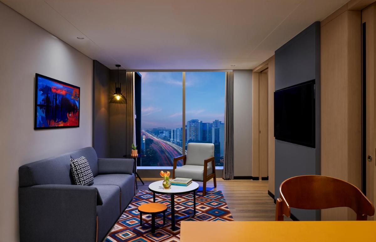 a living room with a couch and a table at Hyatt Centric Hebbal Bengaluru in Bengaluru
