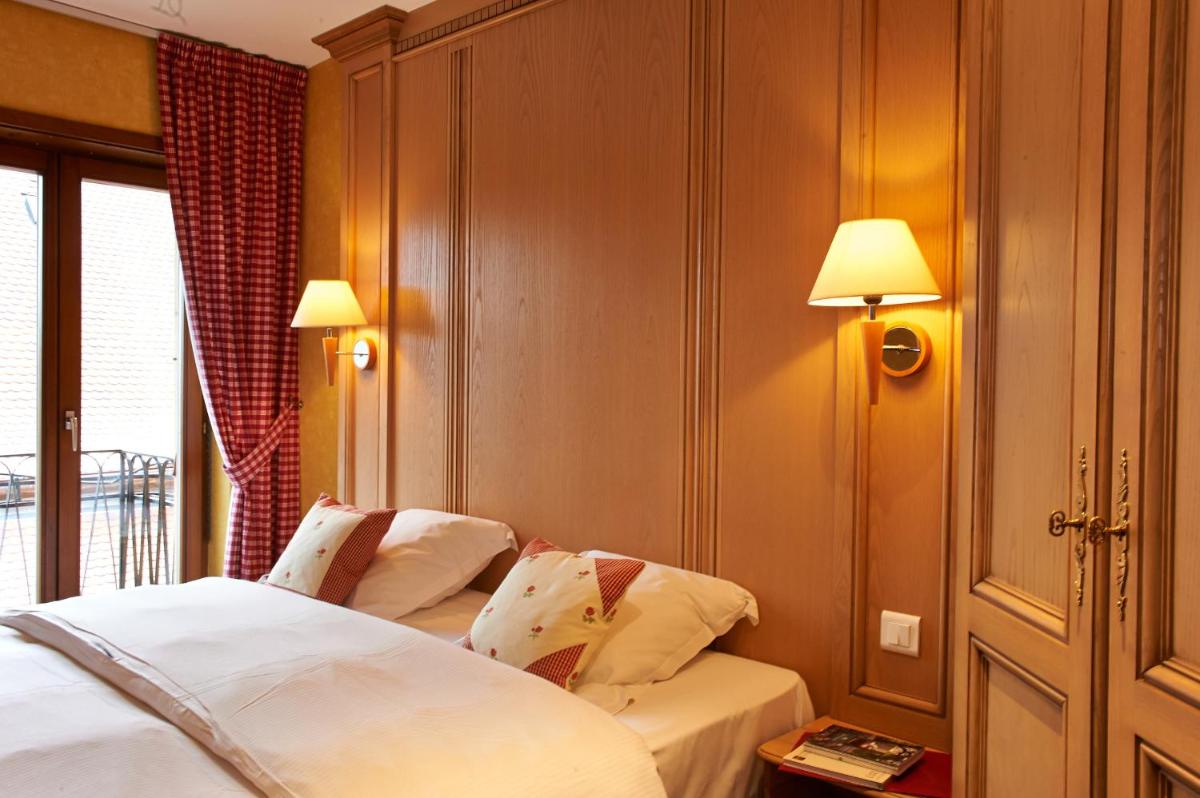 Un ou plusieurs lits dans un hébergement de l'établissement Hotel Spa et Restaurant Au Chasseur
