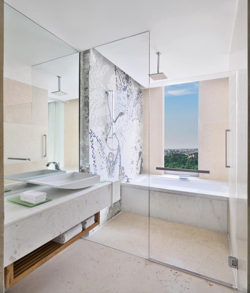 a bathroom with two sinks and a window at The Westin Gurgaon, New Delhi in Gurgaon