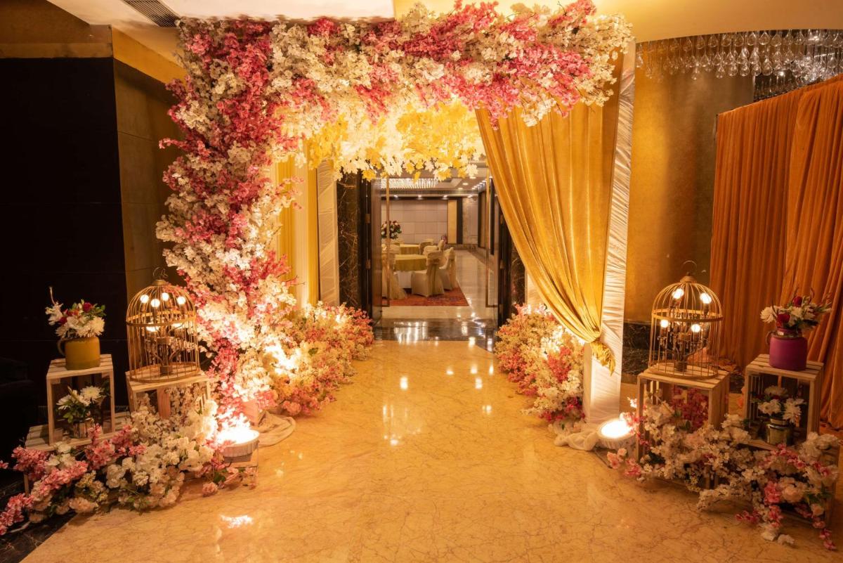a wedding arch with flowers and lights in a room at Radisson Blu Kaushambi Delhi NCR in Ghaziabad