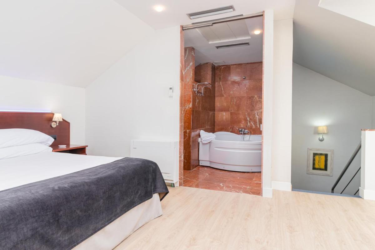 Cama o camas de una habitación en Hotel Milagros Golf