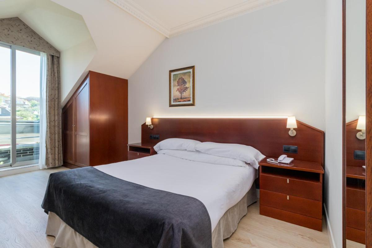 Cama o camas de una habitación en Hotel Milagros Golf