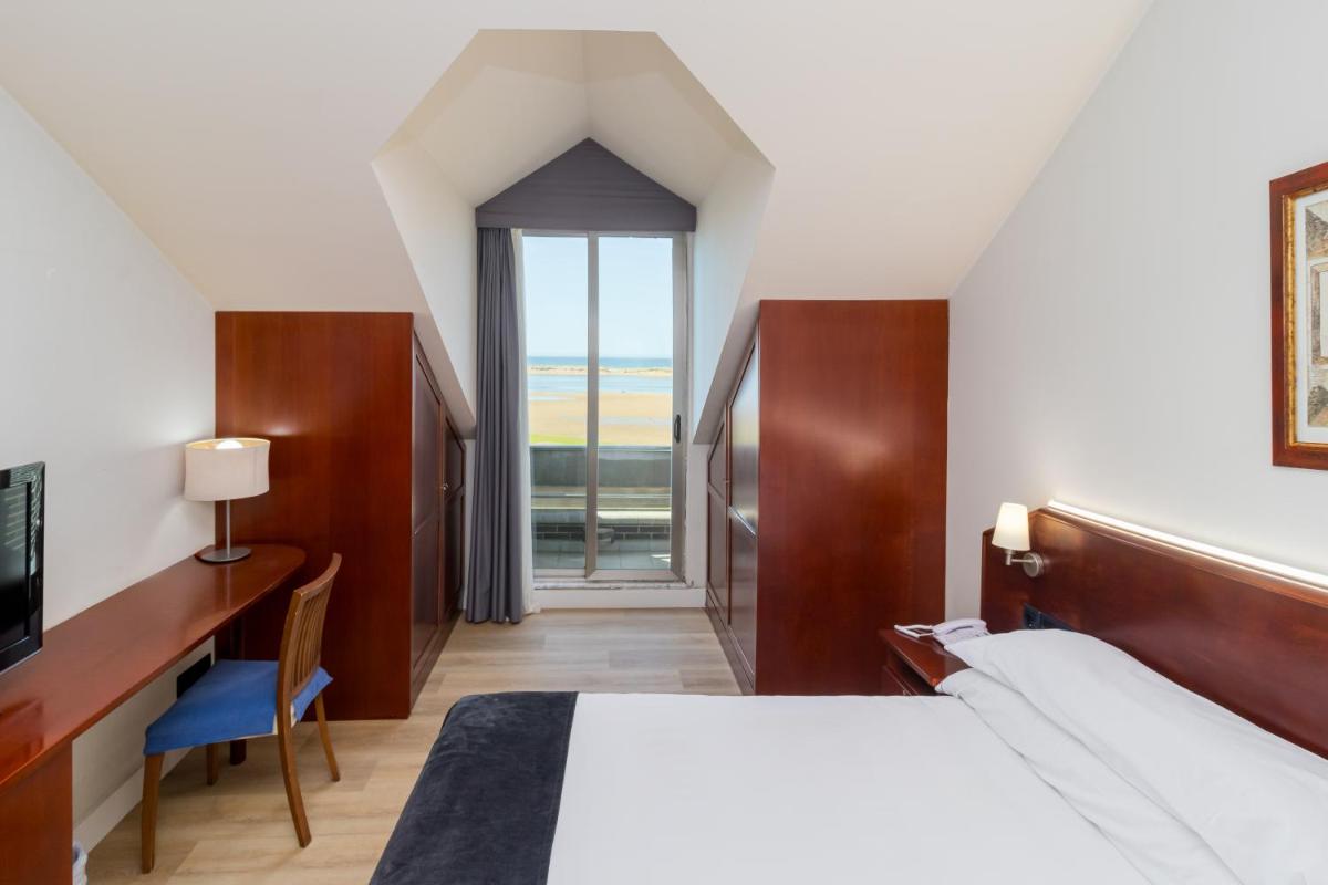 Cama o camas de una habitación en Hotel Milagros Golf