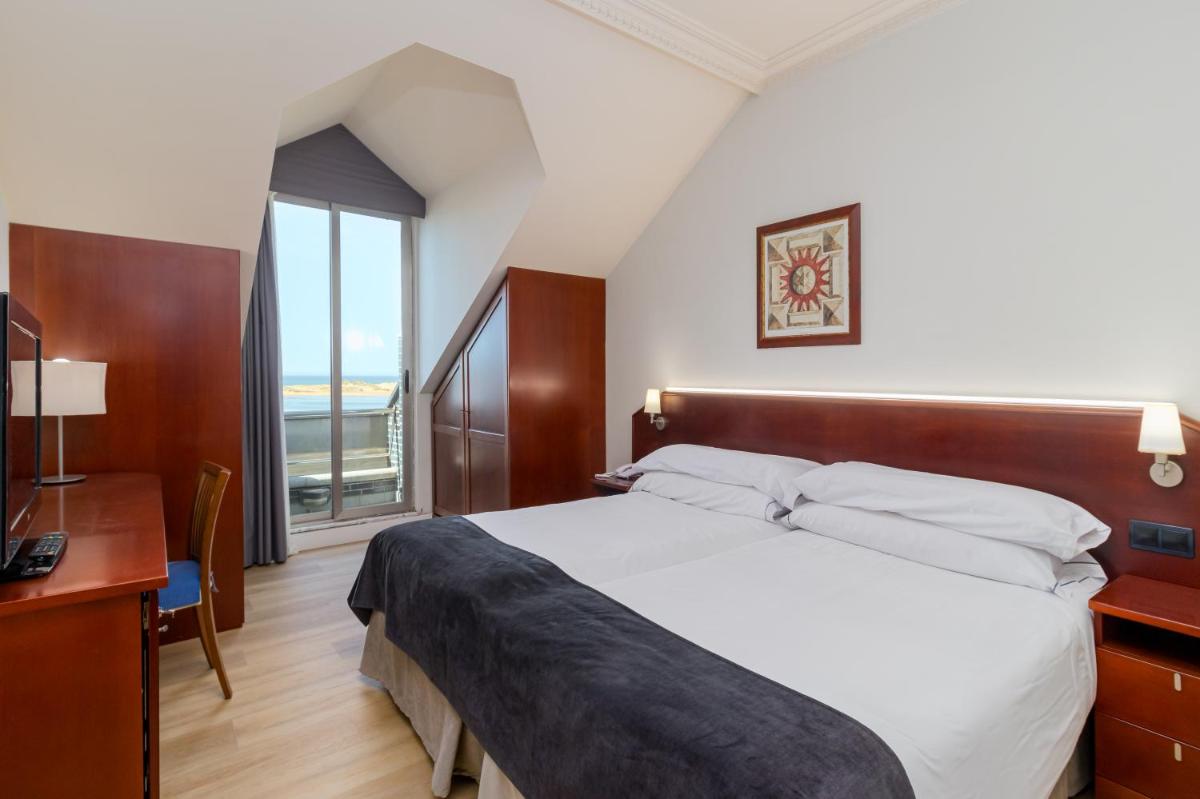 Cama o camas de una habitación en Hotel Milagros Golf