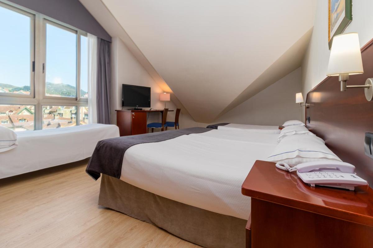 Cama o camas de una habitación en Hotel Milagros Golf