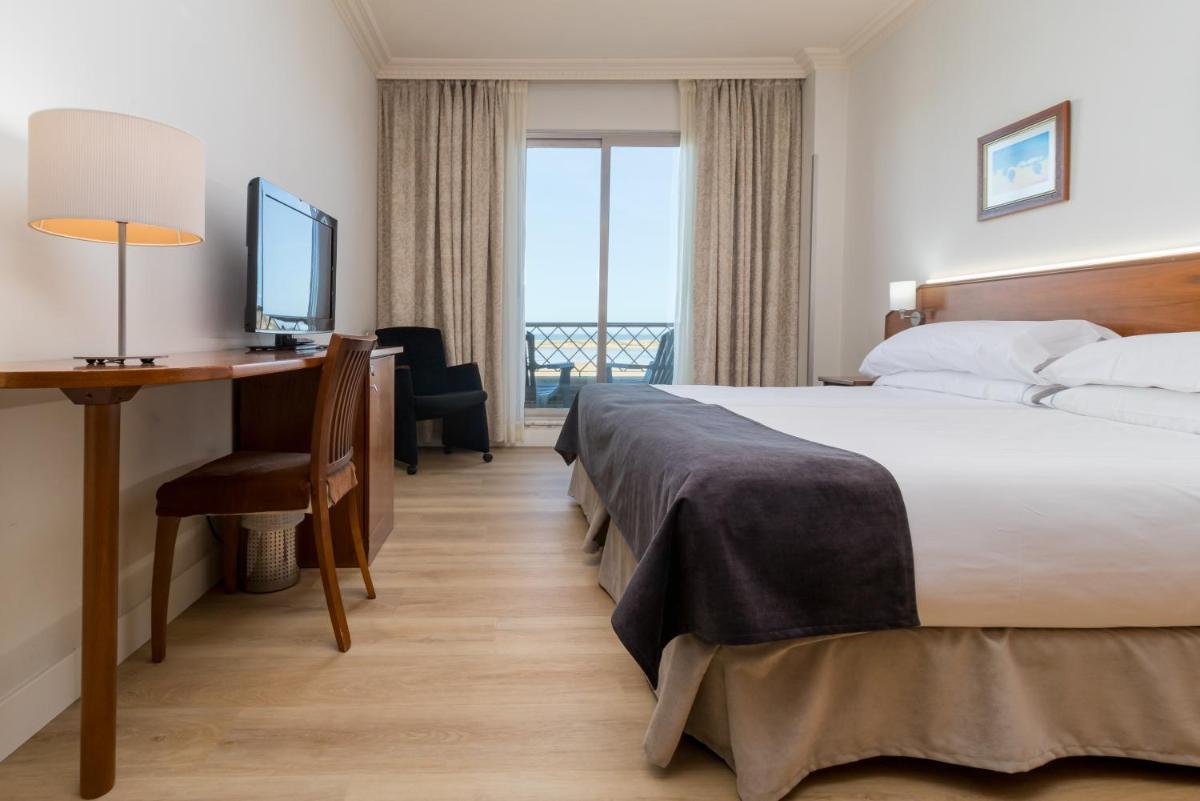 Cama o camas de una habitación en Hotel Milagros Golf