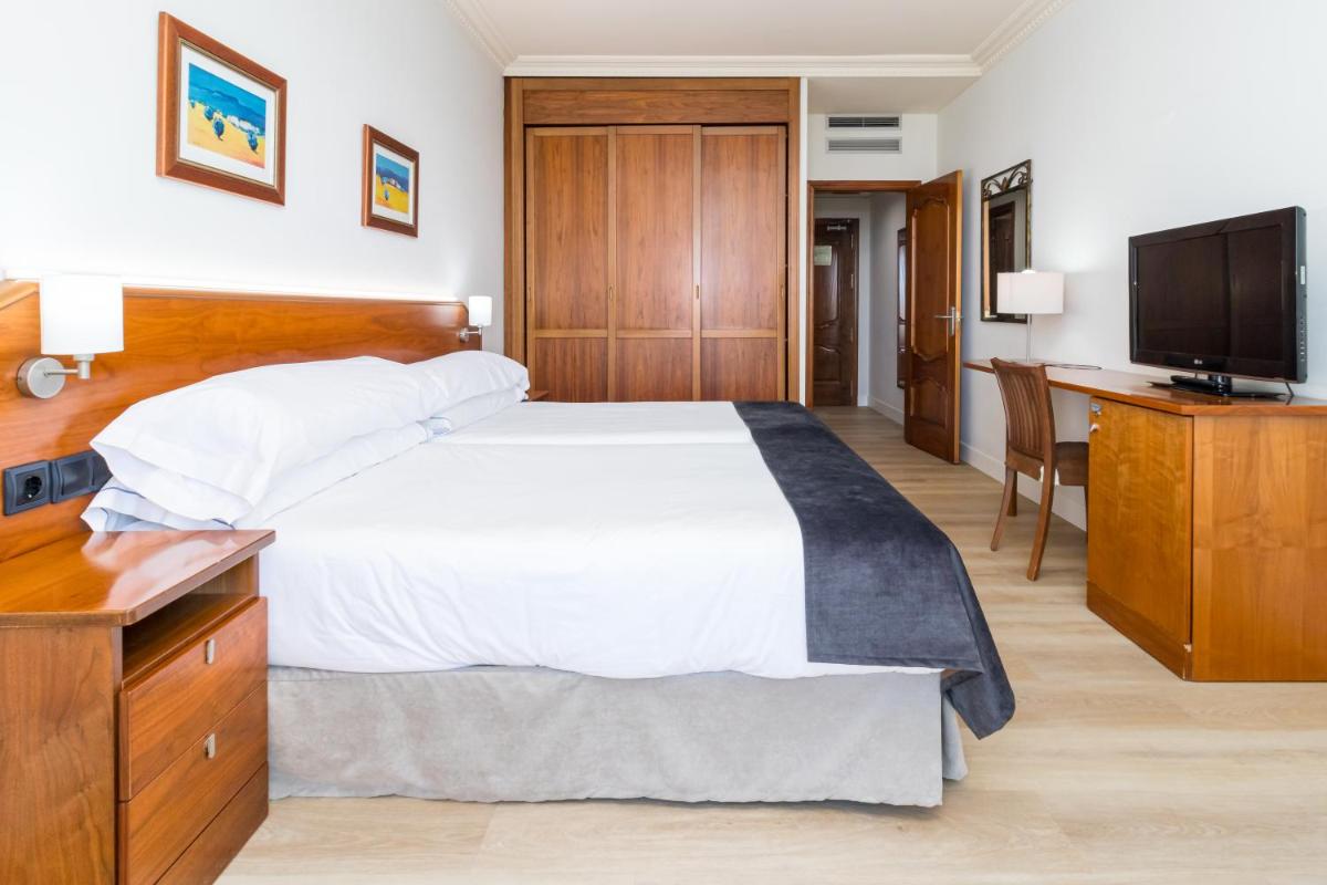 Cama o camas de una habitación en Hotel Milagros Golf
