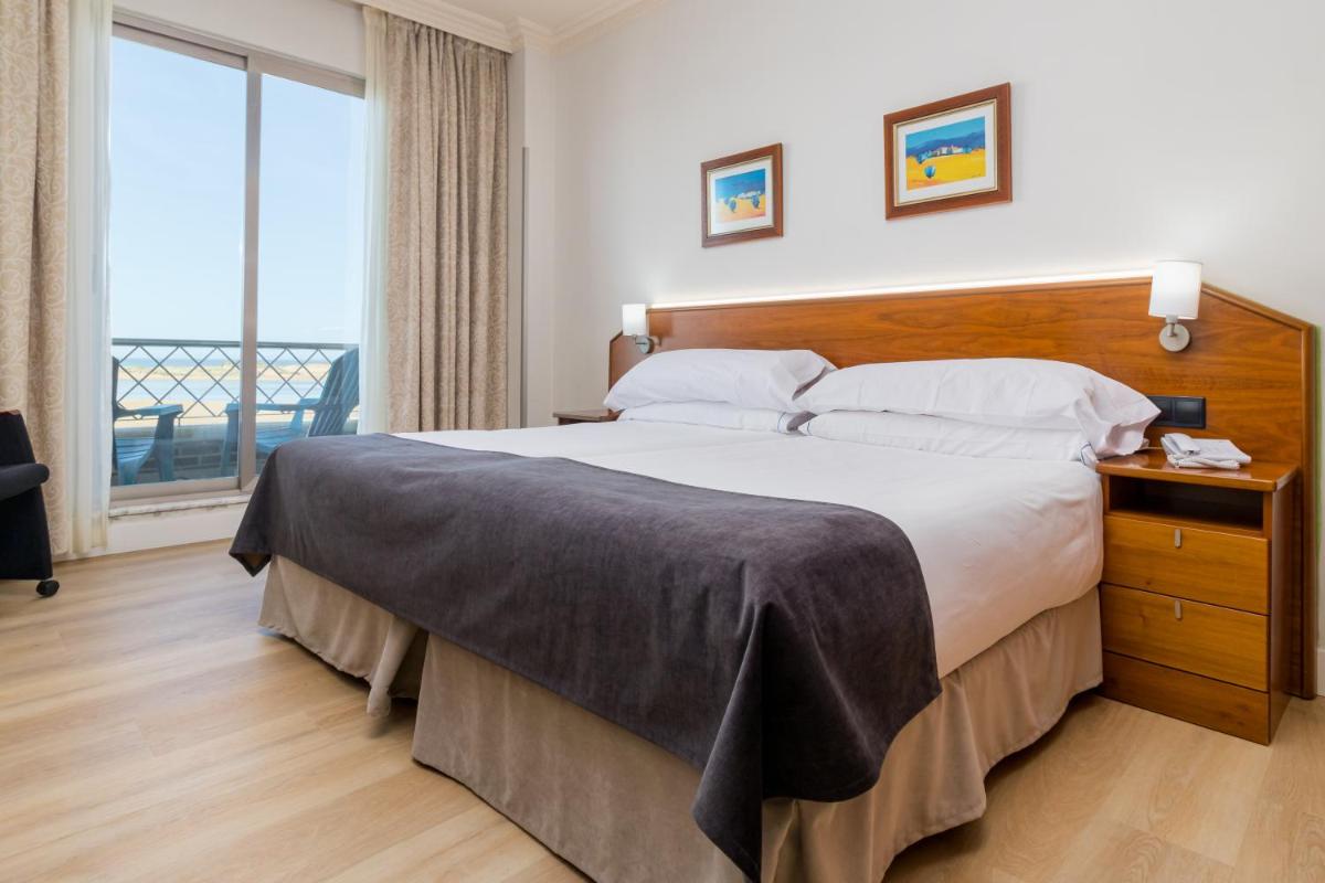 Cama o camas de una habitación en Hotel Milagros Golf