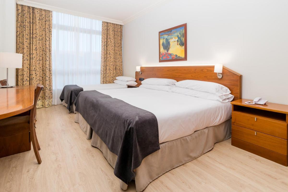 Cama o camas de una habitación en Hotel Milagros Golf