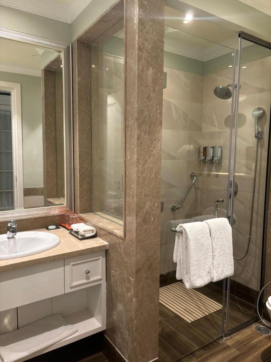 a bathroom with a shower and a sink at Welcomhotel by ITC Hotels, The Savoy, Mussoorie in Mussoorie