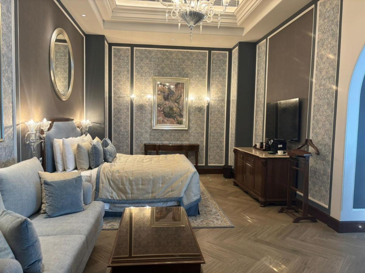 a hotel room with a bed and a couch at Welcomhotel by ITC Hotels, The Savoy, Mussoorie in Mussoorie