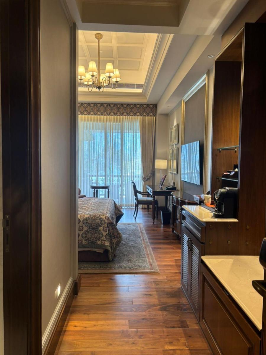 a hotel room with a bed and a dining room at Welcomhotel by ITC Hotels, The Savoy, Mussoorie in Mussoorie