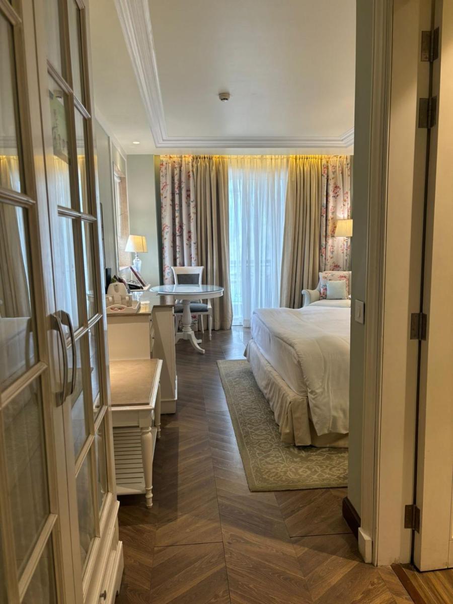 a hotel room with a bed and a desk and a desk at Welcomhotel by ITC Hotels, The Savoy, Mussoorie in Mussoorie