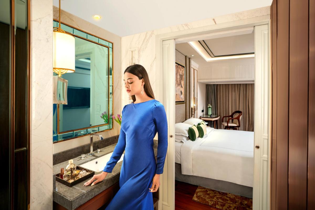 a woman in a blue dress standing in a hotel room at Taj MG Road Bengaluru in Bengaluru a woman in a blue dress standing in a hotel room at Taj MG Road Bengaluru in Bengaluru
