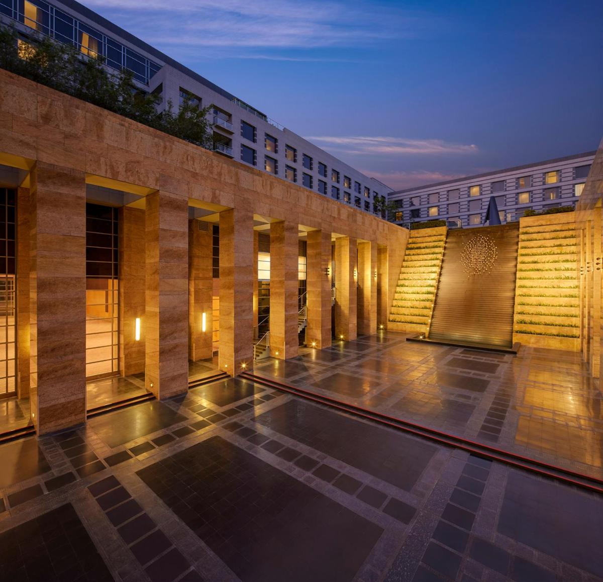 a building with a swimming pool in front of it at Grand Hyatt Mumbai Hotel and Residences in Mumbai