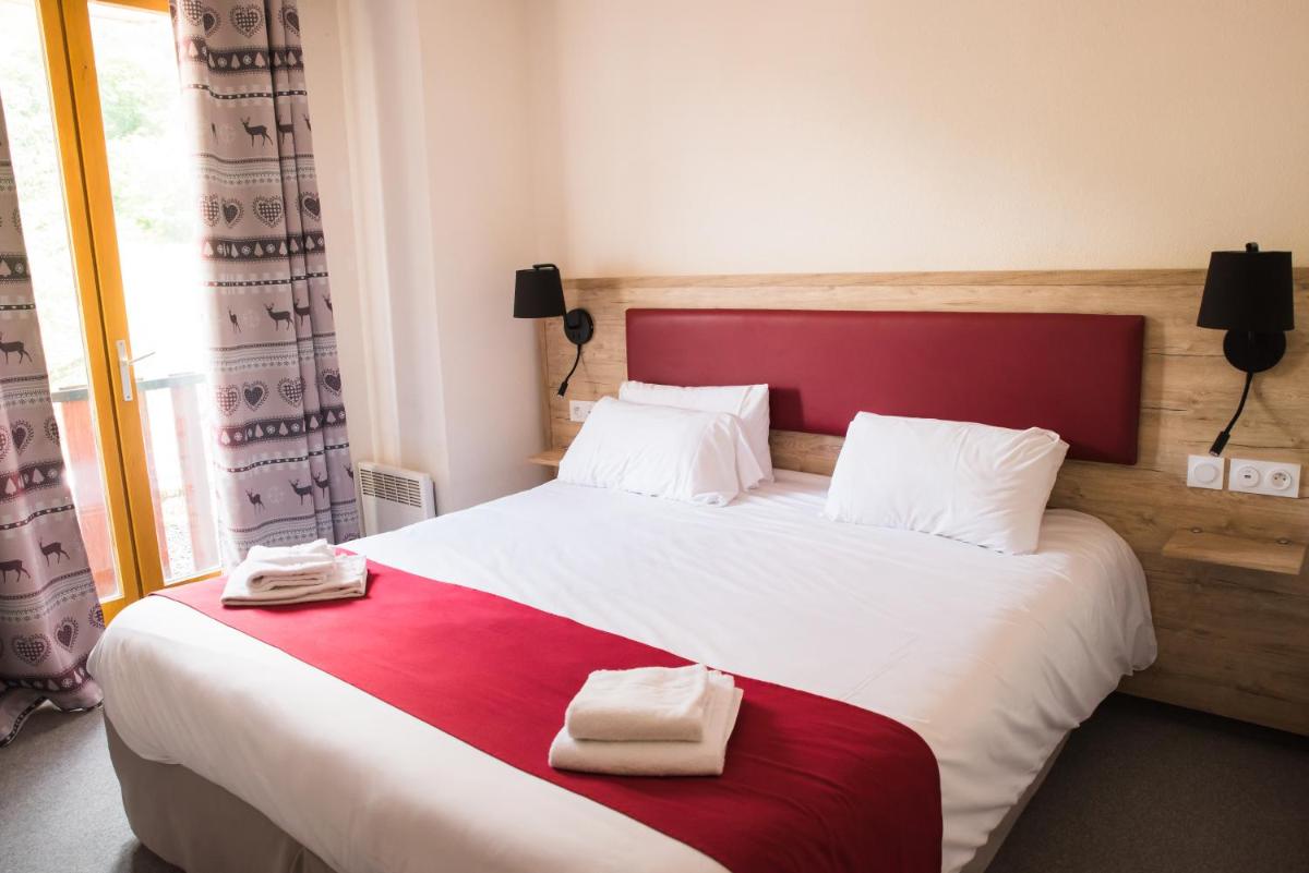 Un ou plusieurs lits dans un hébergement de l'établissement Hôtel Espace Montclar