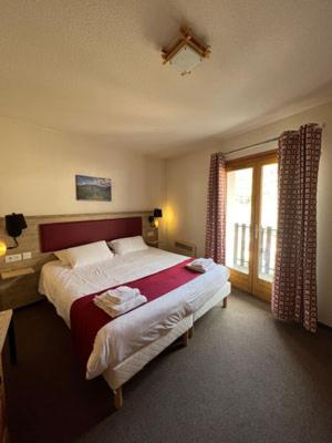 Un ou plusieurs lits dans un hébergement de l'établissement Hôtel Espace Montclar