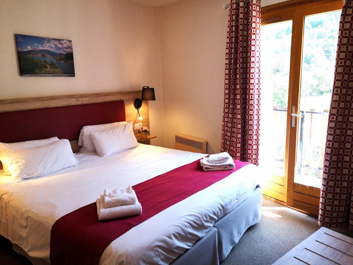Un ou plusieurs lits dans un hébergement de l'établissement Hôtel Espace Montclar