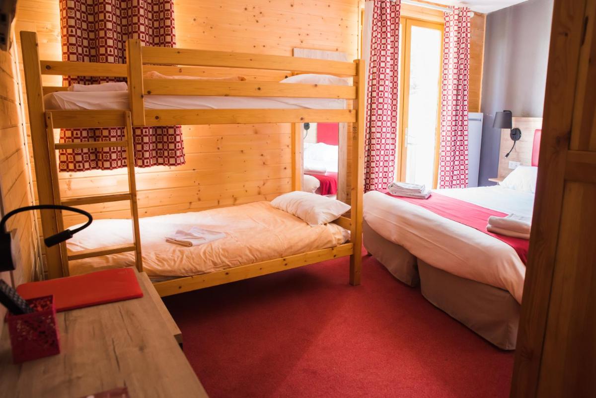 Un ou plusieurs lits dans un hébergement de l'établissement Hôtel Espace Montclar