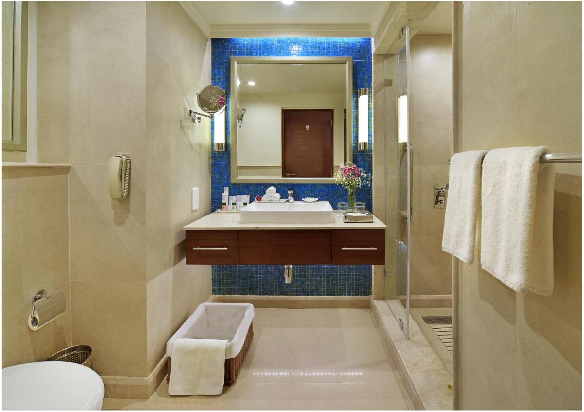 a bathroom with a sink and a toilet and a mirror at Fortune Miramar, Goa - Member ITC Hotels' Group in Panaji a bathroom with a sink and a toilet and a mirror at Fortune Miramar, Goa - Member ITC Hotels' Group in Panaji