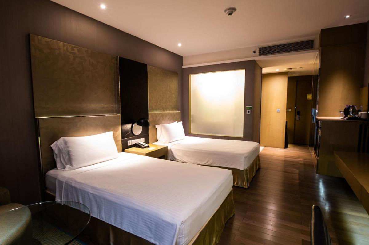 a hotel room with two beds and a window at Holiday Inn New Delhi Aerocity by IHG in New Delhi