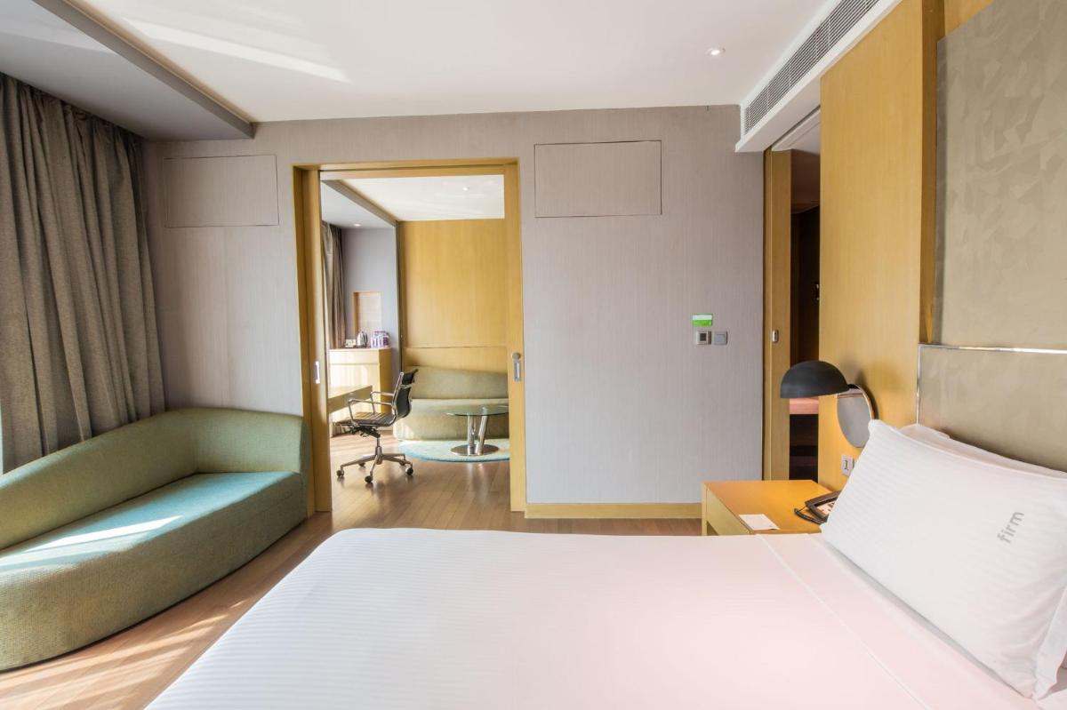 a hotel room with a bed and a desk at Holiday Inn New Delhi Aerocity by IHG in New Delhi