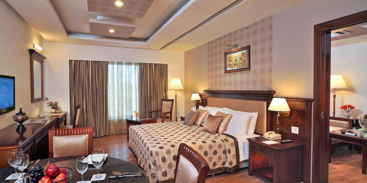 a hotel room with a bed and a desk at Fortune JP Palace, Mysore - Member ITC Hotels' Group in Mysore