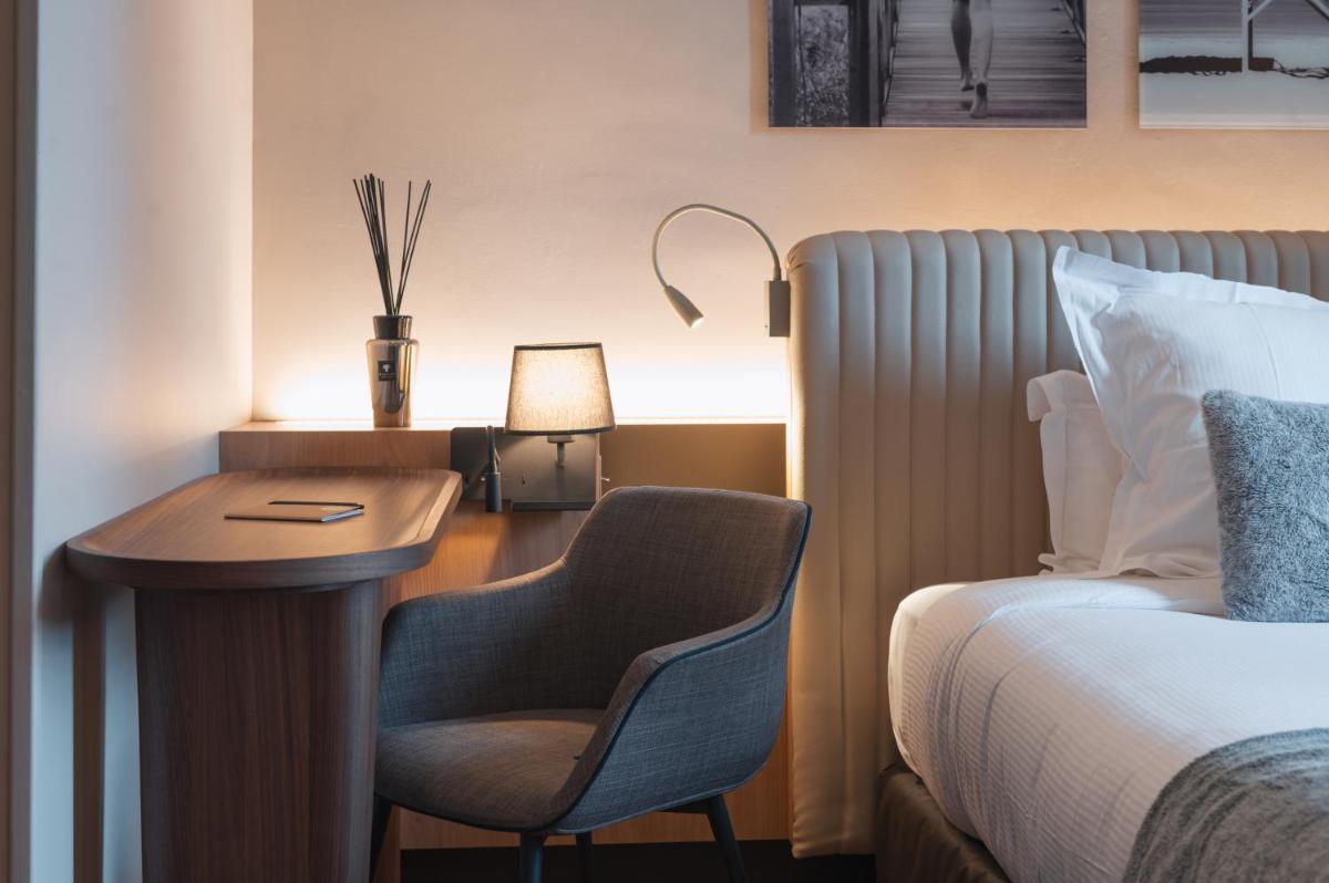 Un ou plusieurs lits dans un hébergement de l'établissement Le Monastère de Saint Mont Hôtel & Spa