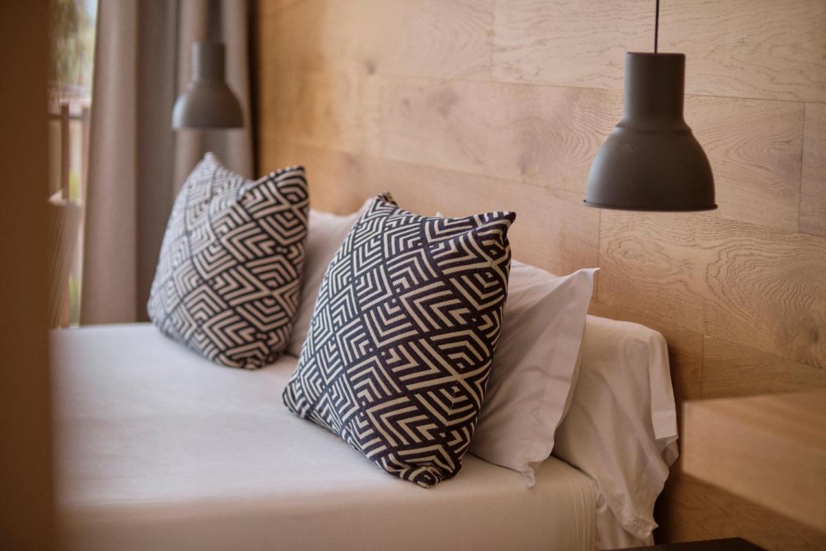Cama o camas de una habitación en Las Gaviotas Suites Hotel & Spa