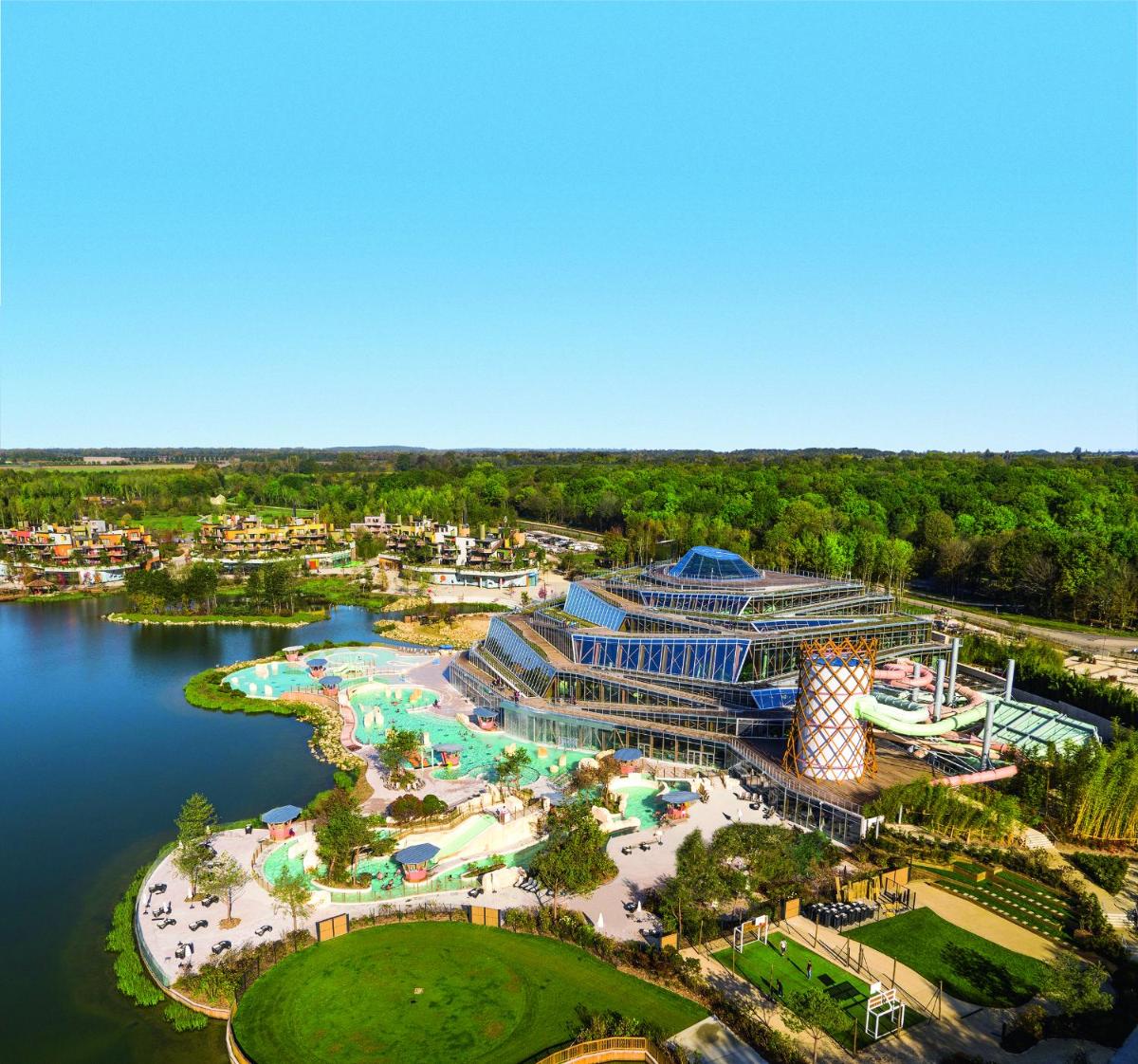 Una vista aérea de un complejo turístico junto a un cuerpo de agua. en Center Parcs Villages Nature Paris, en Bailly-Romainvilliers