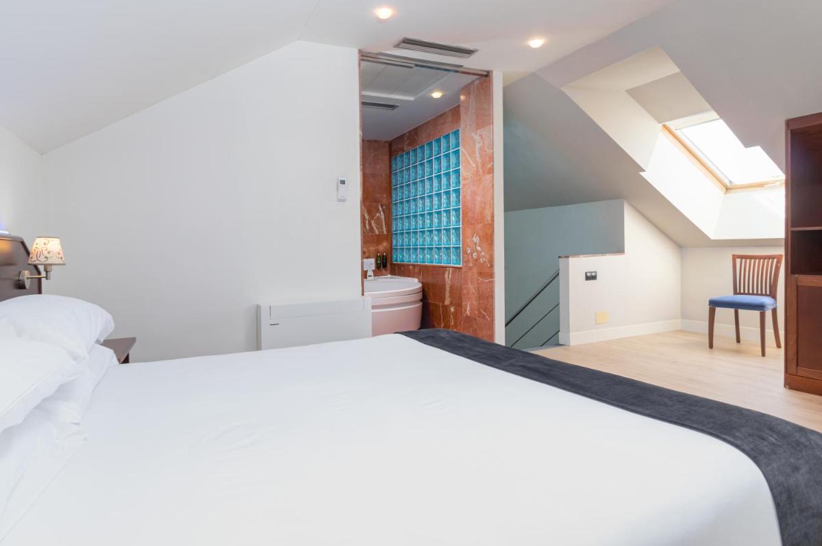 Cama o camas de una habitación en Hotel Milagros Golf