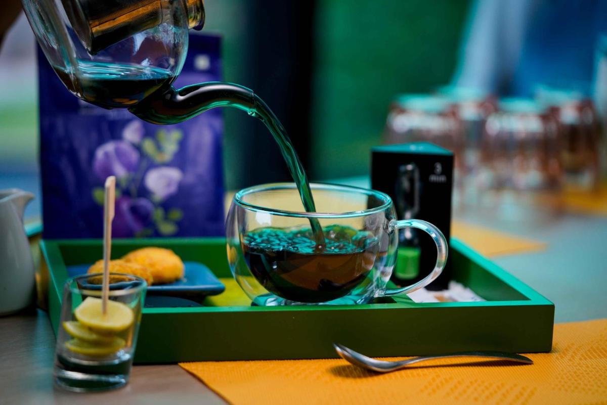 a drink is being poured into a cup on a tray at Novotel Kolkata Hotel and Residences in Kolkata a drink is being poured into a cup on a tray at Novotel Kolkata Hotel and Residences in Kolkata