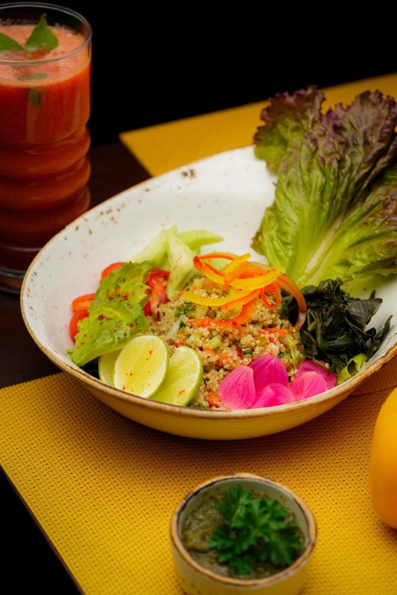 a plate of food with vegetables on a table at Novotel Kolkata Hotel and Residences in Kolkata a plate of food with vegetables on a table at Novotel Kolkata Hotel and Residences in Kolkata