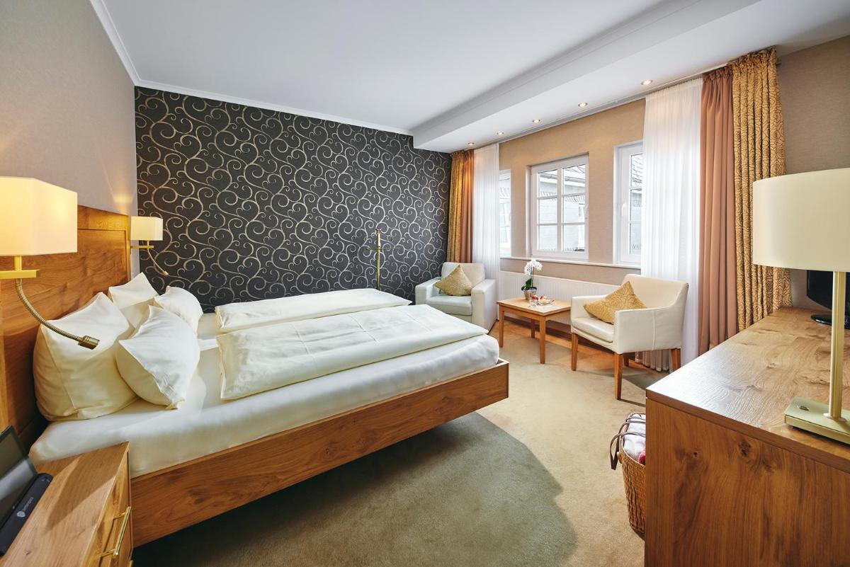 Ein Bett oder Betten in einem Zimmer der Unterkunft Hotel Deimann