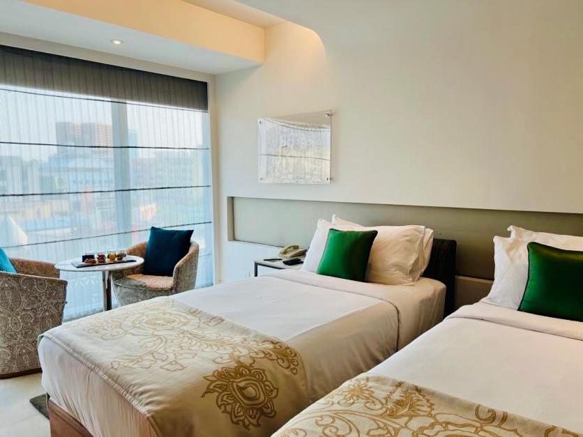 a hotel room with two beds and a window at The Park Hyderabad, Banjara Hills near Hussain Sagar Lake in Hyderabad a hotel room with two beds and a window at The Park Hyderabad, Banjara Hills near Hussain Sagar Lake in Hyderabad