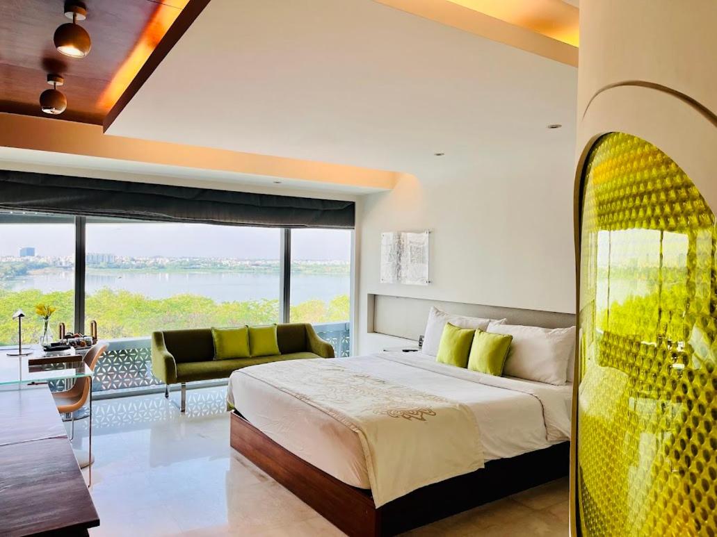 a bedroom with a bed and a view of the water at The Park Hyderabad, Banjara Hills near Hussain Sagar Lake in Hyderabad a bedroom with a bed and a view of the water at The Park Hyderabad, Banjara Hills near Hussain Sagar Lake in Hyderabad