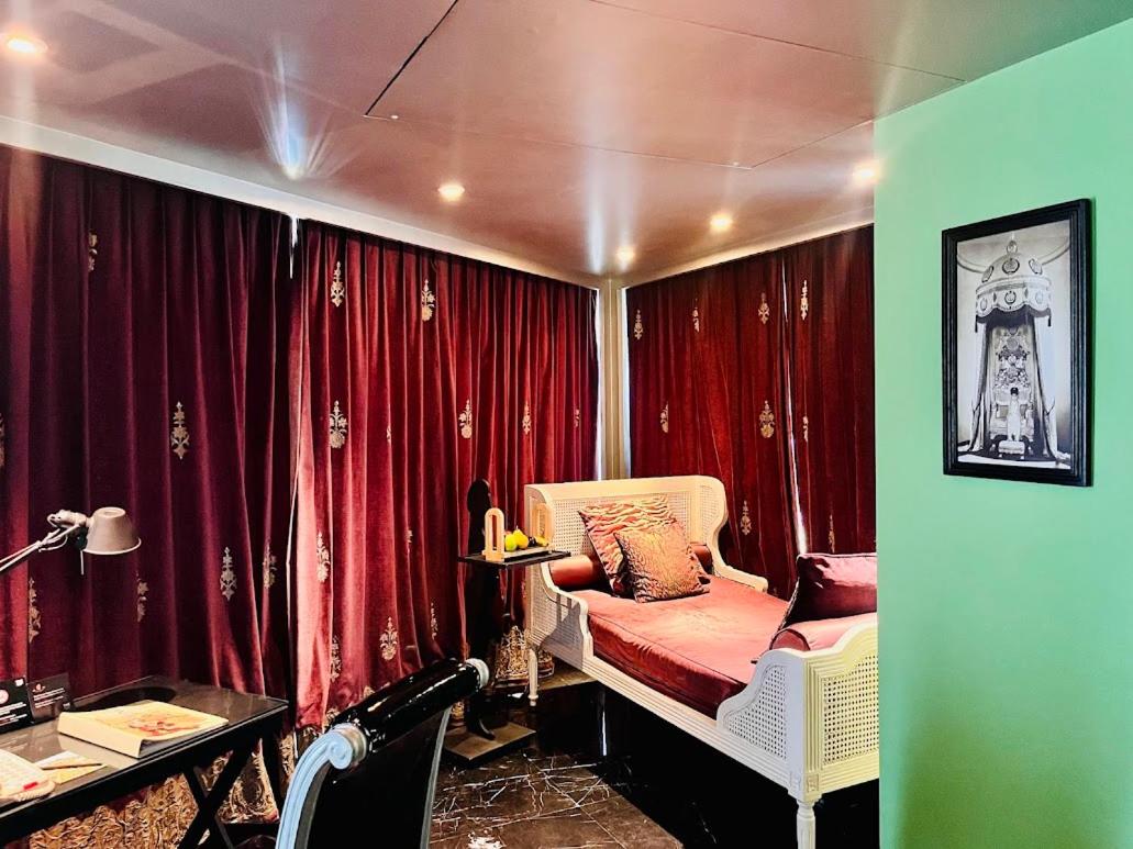 a room with red curtains and a bed with a chair at The Park Hyderabad, Banjara Hills near Hussain Sagar Lake in Hyderabad a room with red curtains and a bed with a chair at The Park Hyderabad, Banjara Hills near Hussain Sagar Lake in Hyderabad
