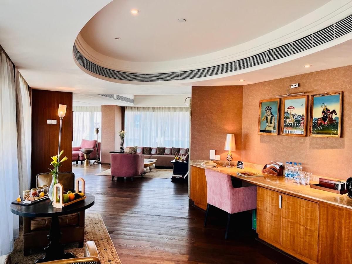 a hotel lobby with a bar and a living room at The Park Hyderabad, Banjara Hills near Hussain Sagar Lake in Hyderabad a hotel lobby with a bar and a living room at The Park Hyderabad, Banjara Hills near Hussain Sagar Lake in Hyderabad