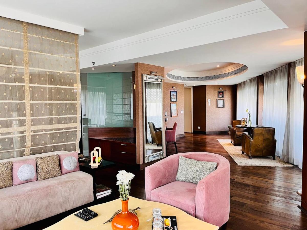 a living room with pink furniture and a piano at The Park Hyderabad, Banjara Hills near Hussain Sagar Lake in Hyderabad a living room with pink furniture and a piano at The Park Hyderabad, Banjara Hills near Hussain Sagar Lake in Hyderabad