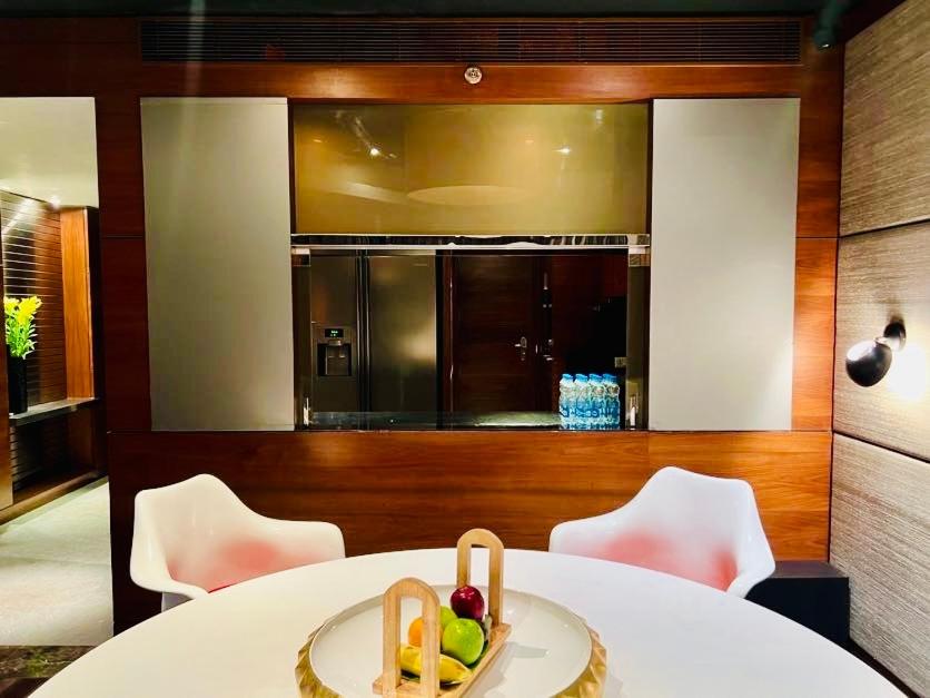 a kitchen with a table with a bowl of fruit on it at The Park Hyderabad, Banjara Hills near Hussain Sagar Lake in Hyderabad a kitchen with a table with a bowl of fruit on it at The Park Hyderabad, Banjara Hills near Hussain Sagar Lake in Hyderabad