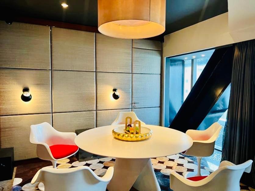 a dining room with a table and chairs at The Park Hyderabad, Banjara Hills near Hussain Sagar Lake in Hyderabad a dining room with a table and chairs at The Park Hyderabad, Banjara Hills near Hussain Sagar Lake in Hyderabad