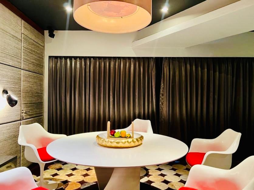 a room with a table and chairs with a cake on it at The Park Hyderabad, Banjara Hills near Hussain Sagar Lake in Hyderabad a room with a table and chairs with a cake on it at The Park Hyderabad, Banjara Hills near Hussain Sagar Lake in Hyderabad